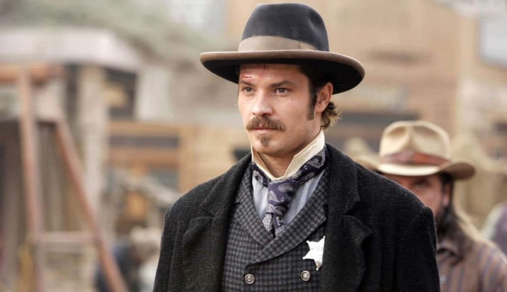 Shows to watch if you like Fallout: Timothy Olyphant wears old cowboy gear as Seth Bullock in Deadwood