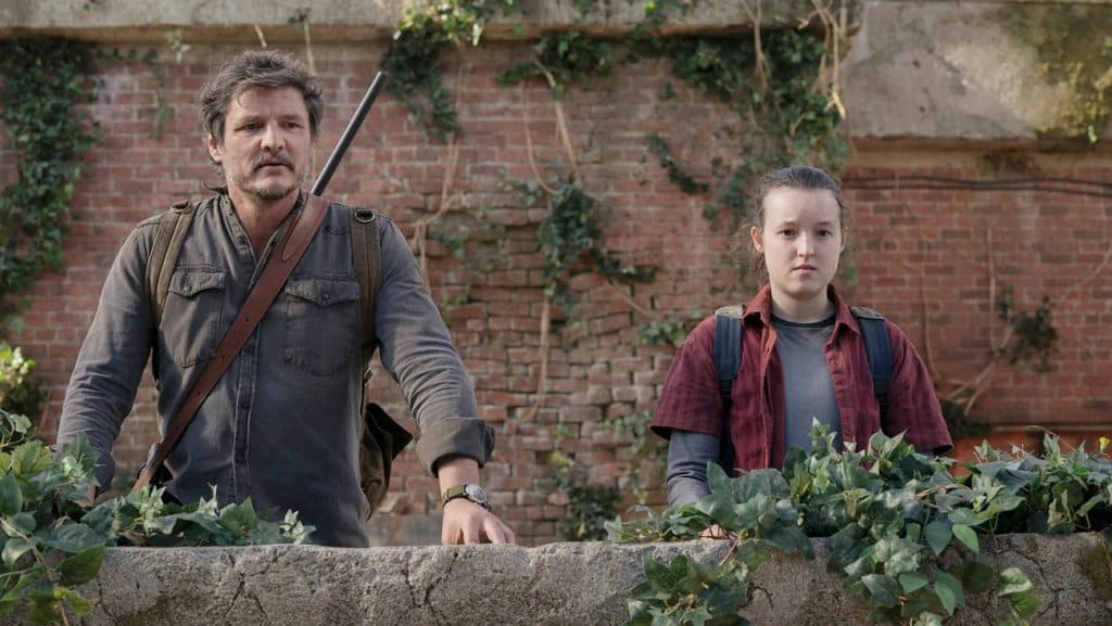 Shows to watch if you like Fallout: Pedro Pascal and Bella Ramsay as Joel and Ellie, standing in an overgrown building in The Last of Us