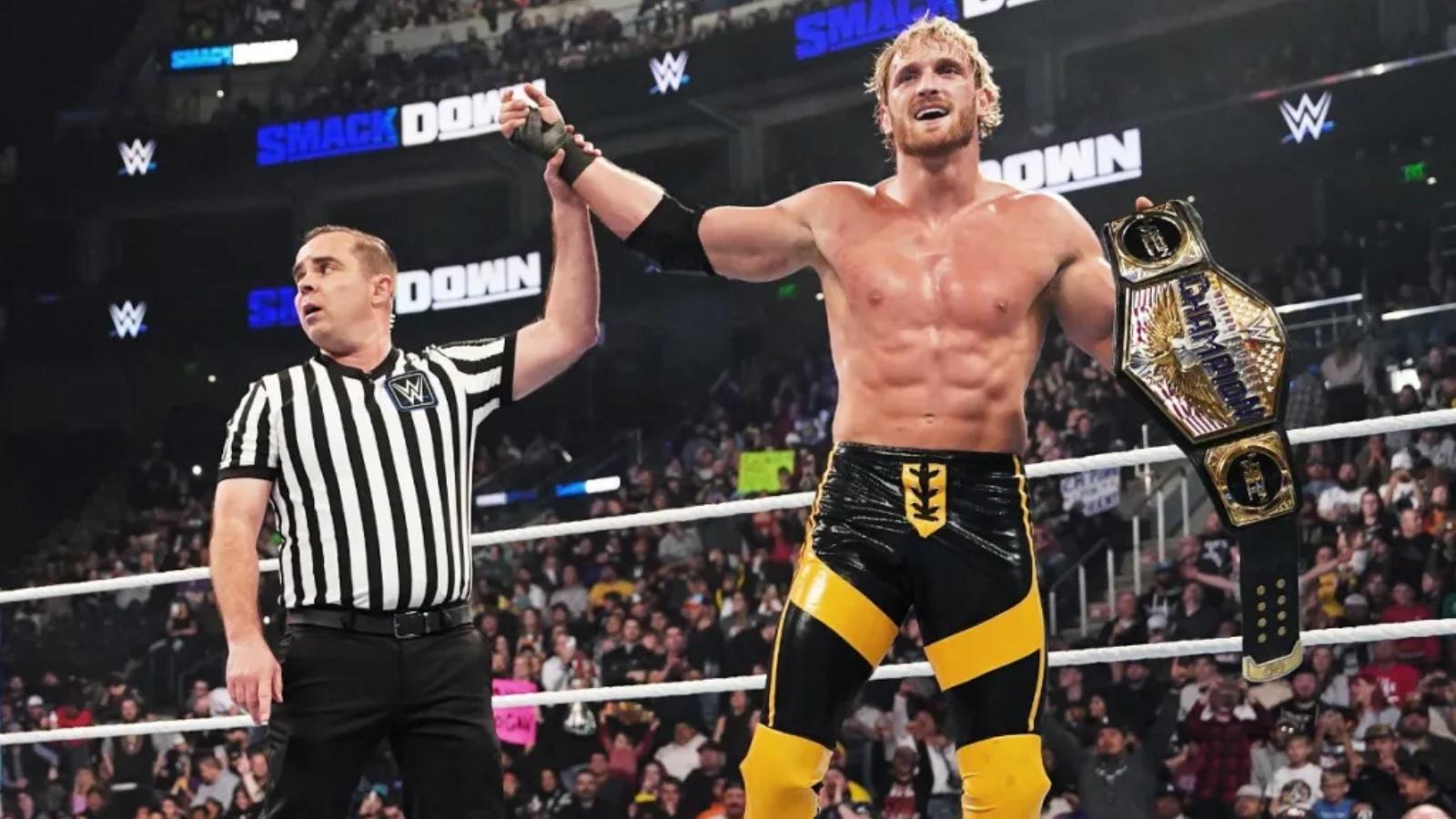 logan paul's hand raised in victory on wwe smackdown