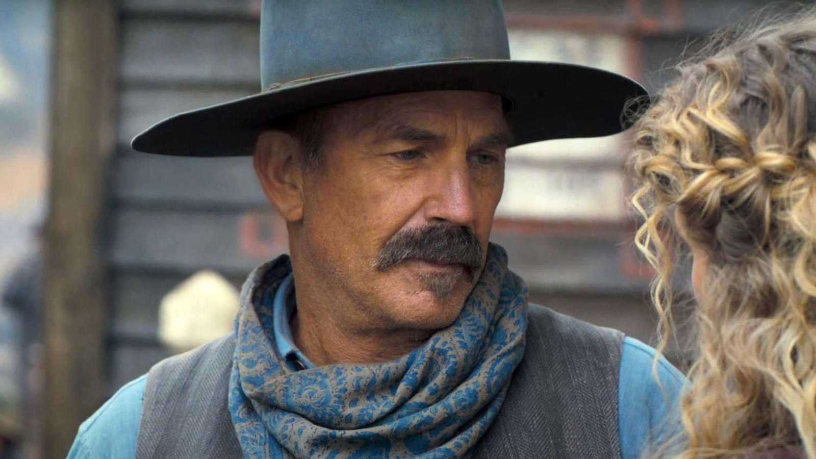 Kevin Costner in Horizon: An American Saga, wearing a cowboy hat and looking at a woman