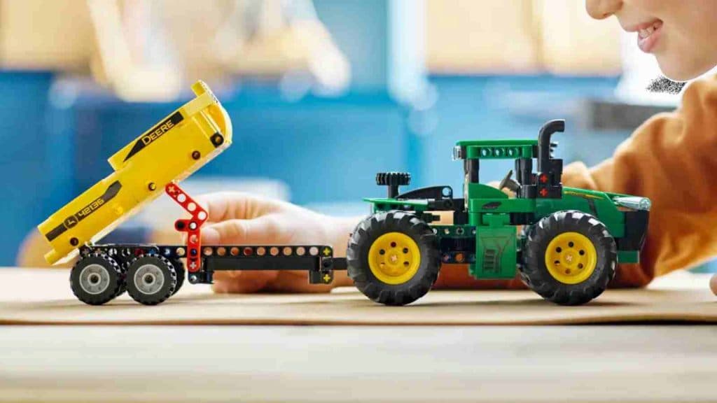 A child with their LEGO Technic John Deere 9620R 4WD Tractor