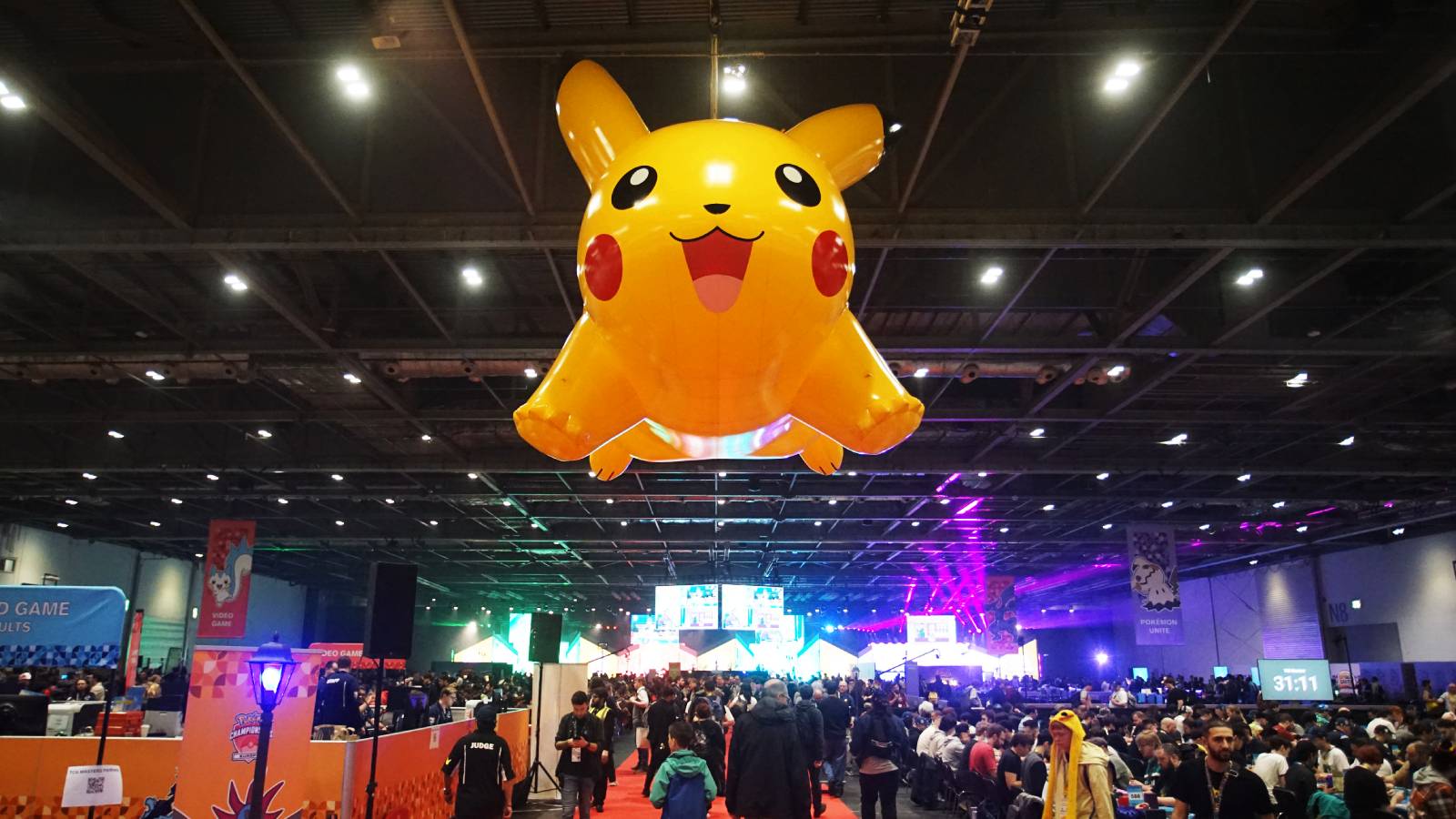 A giant Pikachu looms over a large hall