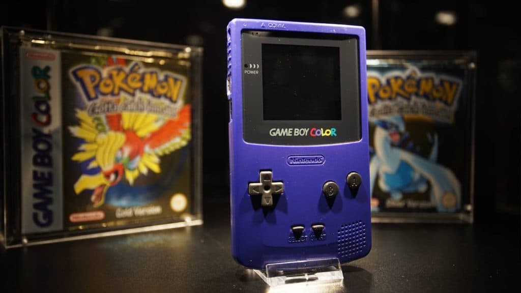 A Game Boy Color is shown in a case
