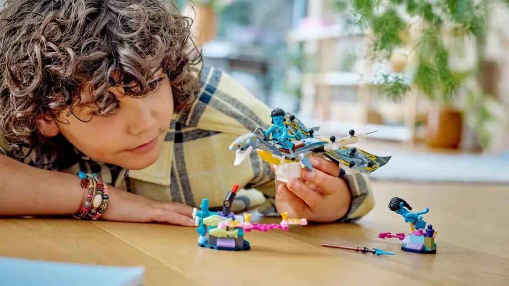 A child playing with their LEGO Avatar Ilu Discovery