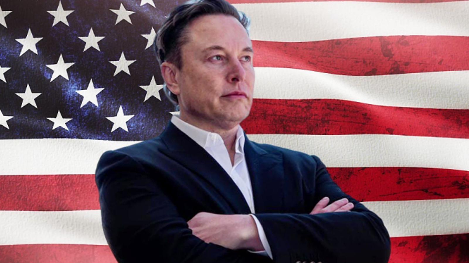 Elon Musk in front of the US flag.