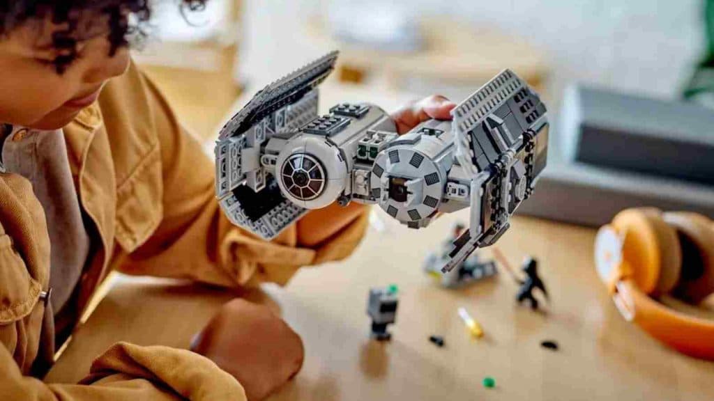 A child playing with their retiring LEGO Star Wars TIE Bomber