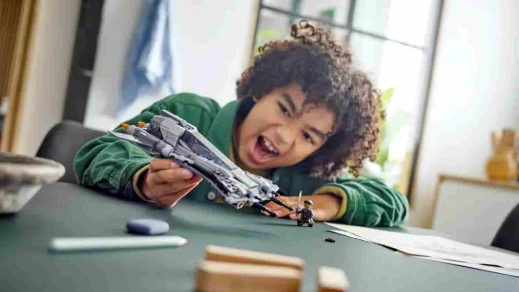 A child playing with the LEGO Star Wars Pirate Snub Fighter