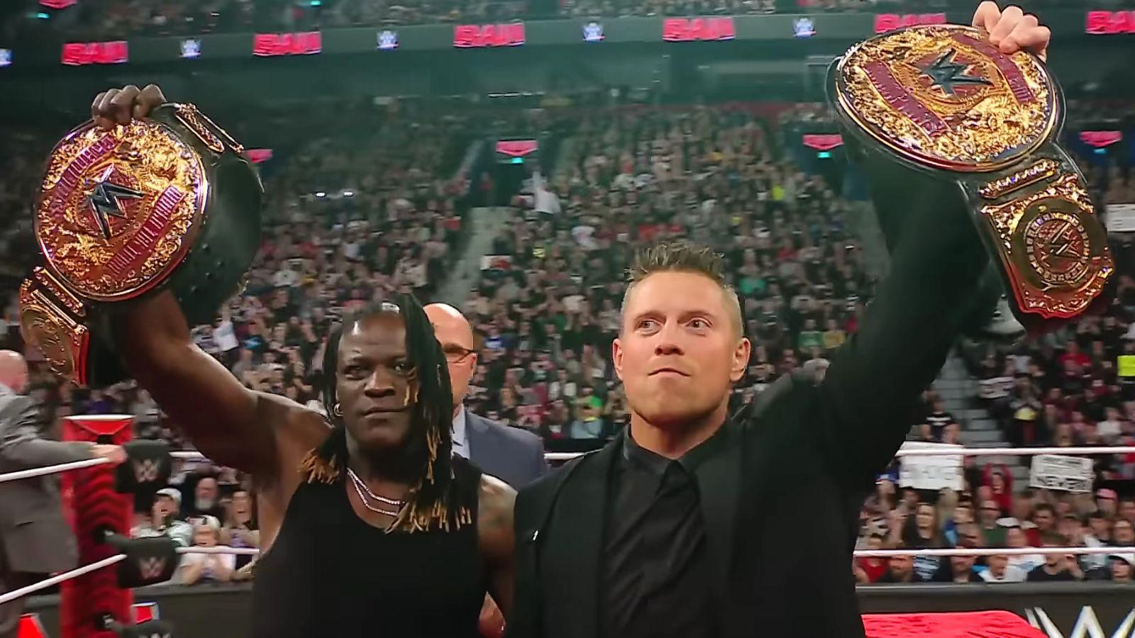 R-Truth (left) and The Miz (right) as part of the tag team duo Awesome Truth holding their World Tag Team Championship belts on the April 15 episode of WWE Raw.