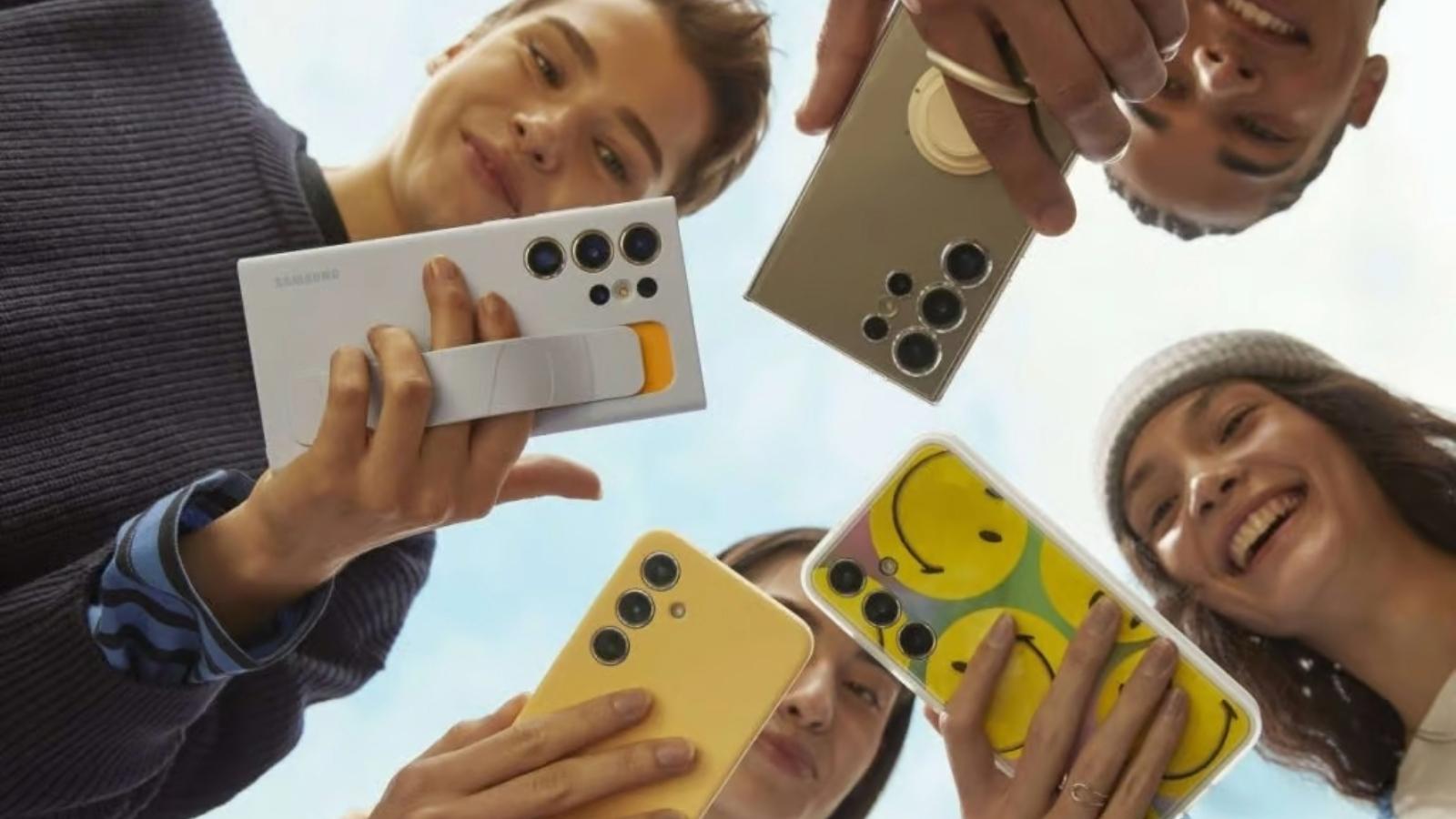 Image showing 4 people holding Samsung Galaxy S24 series in their hands and smiling for the camera.