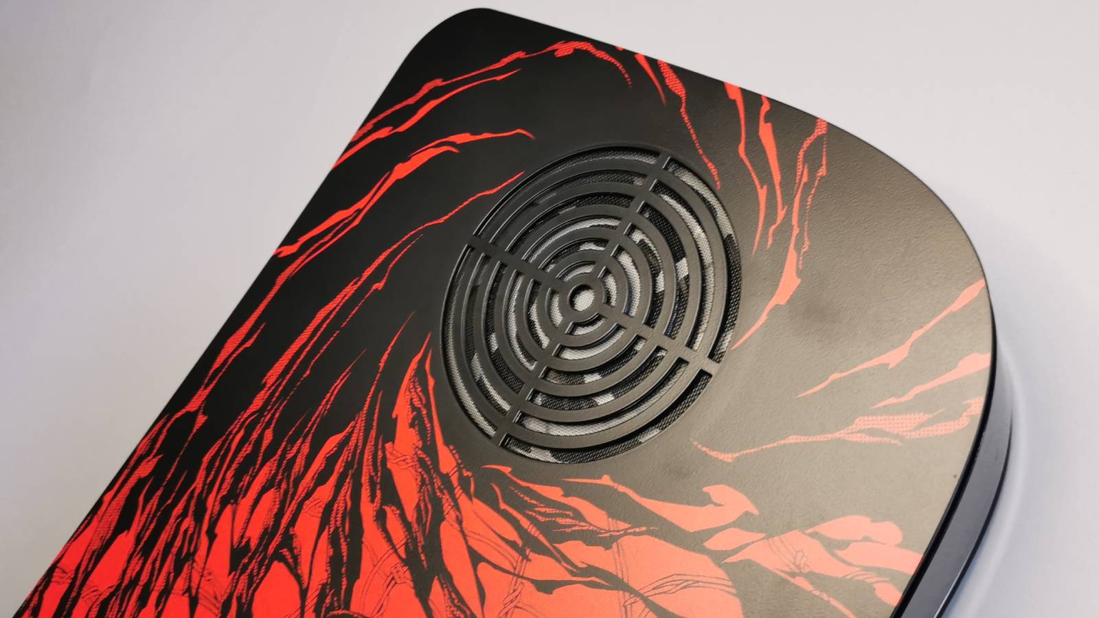 Image of the Dbrand PS5 Arachnoplates cover, against a gray wall background.