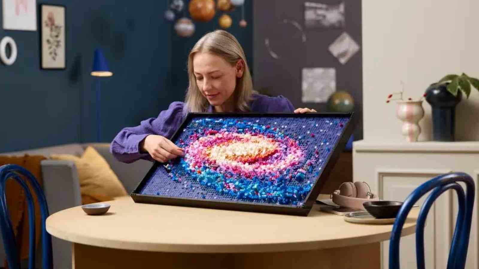 An adult with their LEGO Art The Milky Way Galaxy set