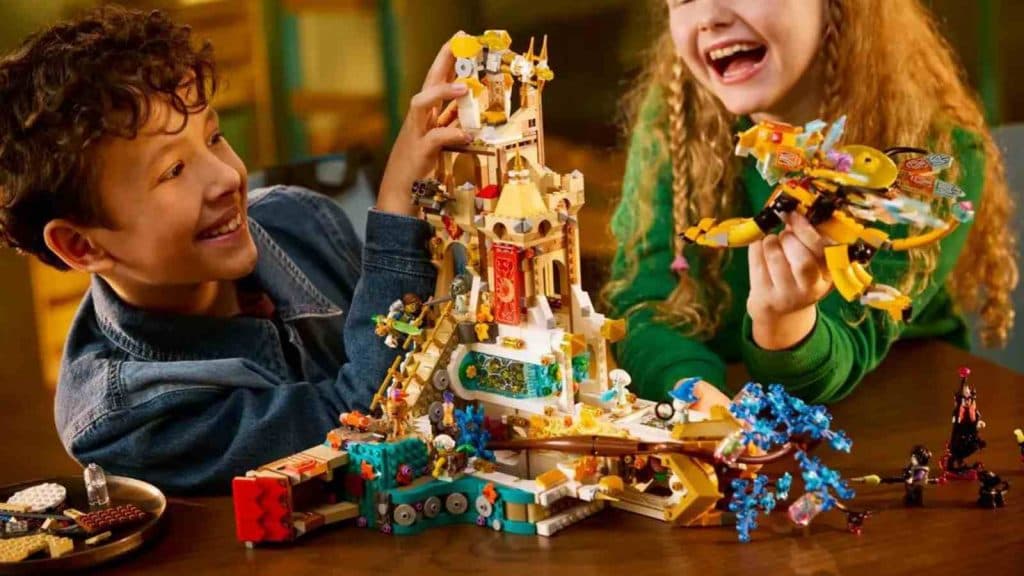 Two children playing with the LEGO DREAMZzz Castle Nocturnia set