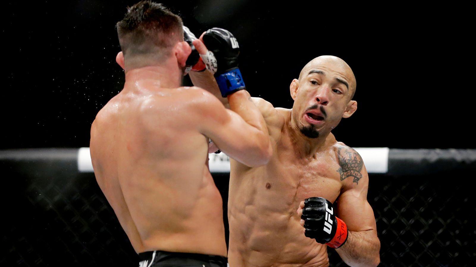 Jose Aldo punches Pedro Munhoz during their fight at UFC 265.