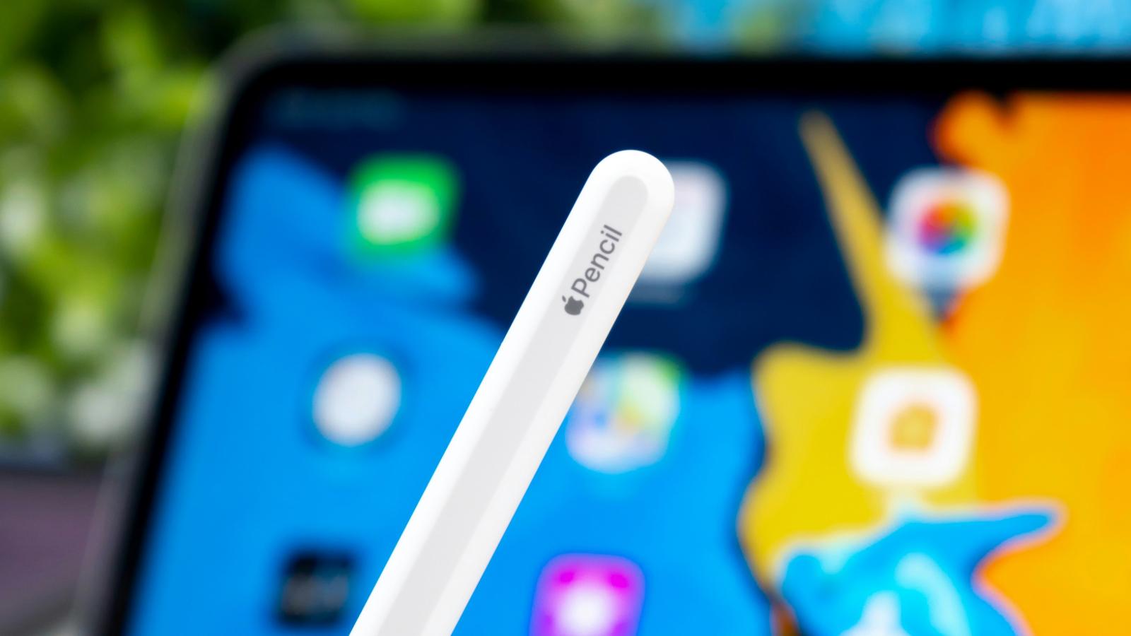 Apple Pencil with a blurred background featuring an iPad