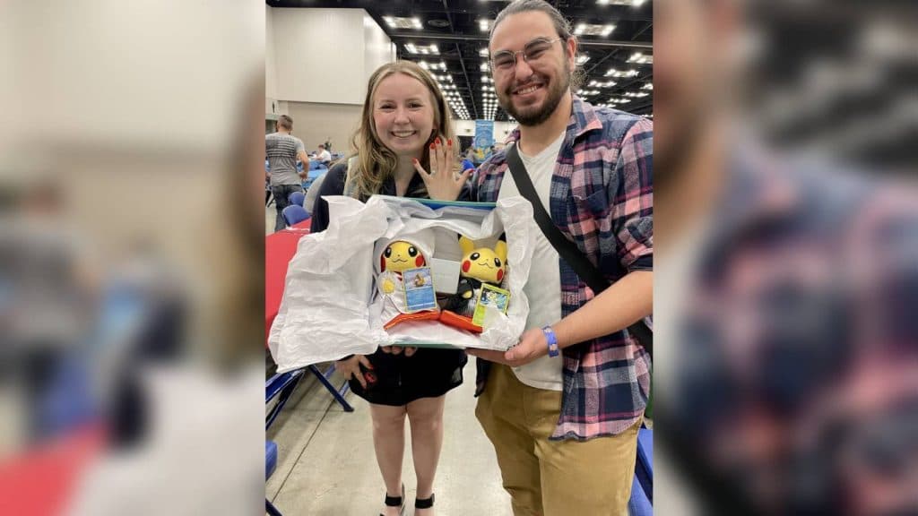 Two Pokemon fans pose with matching bride and groom Pikachu blush, and a women shows off their hand with an engagement ring