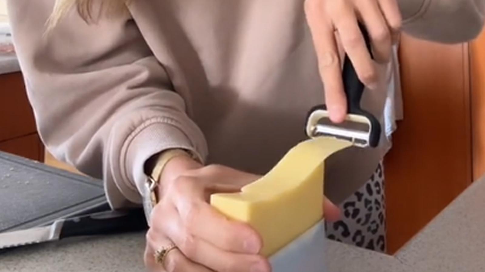 Bella slicing cheese with peeler