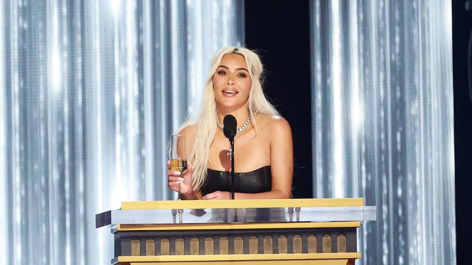 Kim Kardashian standing at the podium at Tom Brady's Roast