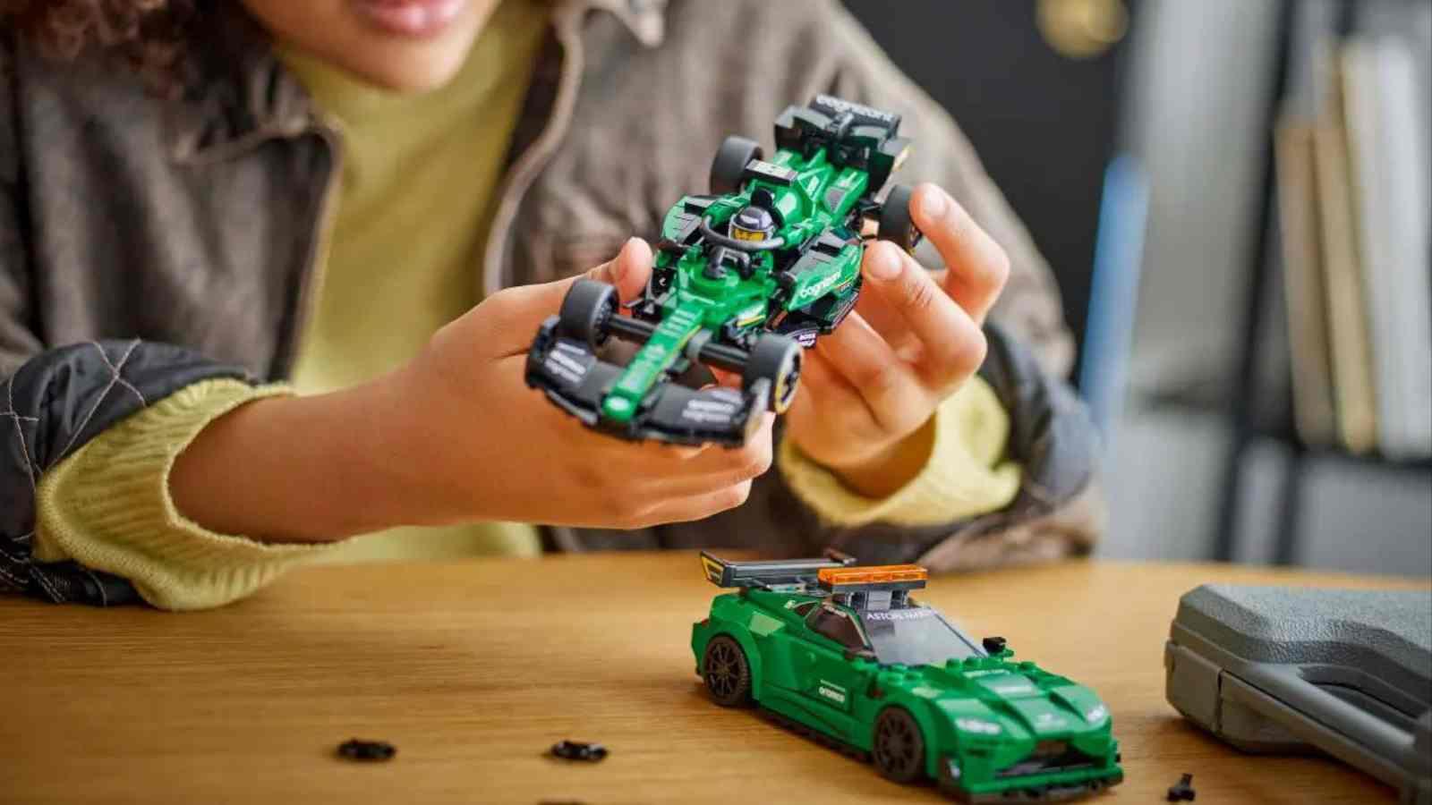 A child playing with the LEGO-reimagined Aston Martin AMR23