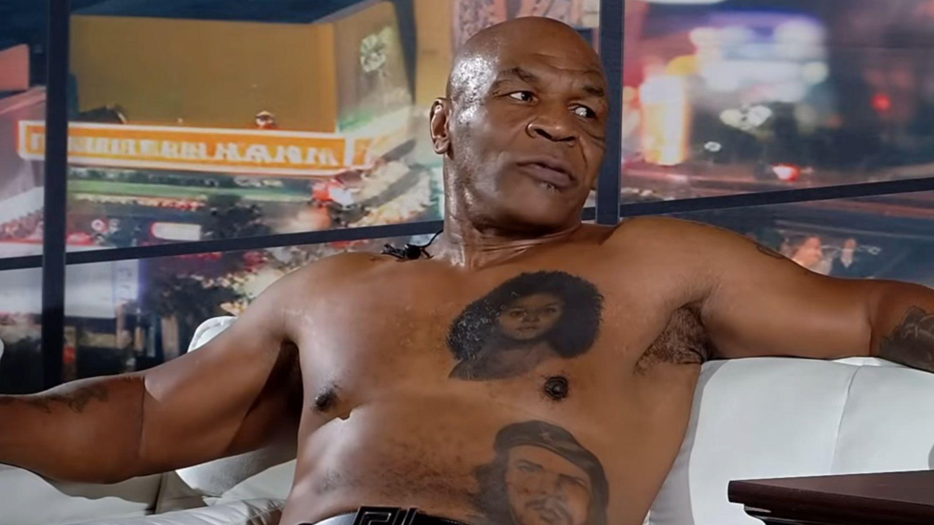 Topless Mike Tyson laying down on couch talking to talk show host