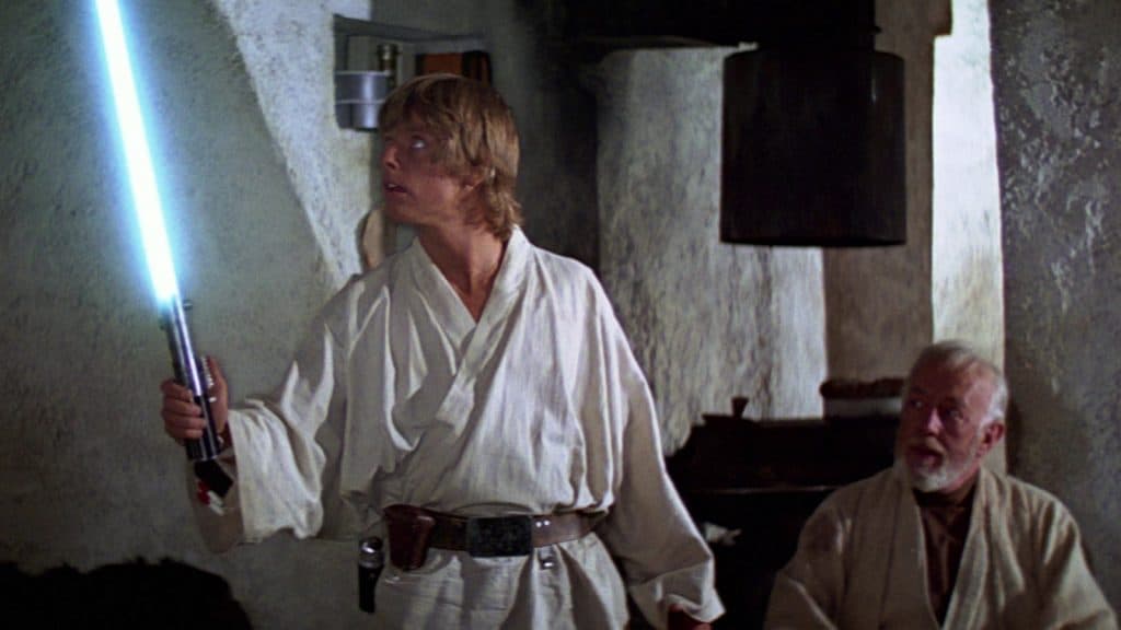 Luke Skywalker receives his father's lightsaber from Obi-Wan Kenobi in Star Wars: A New Hope
