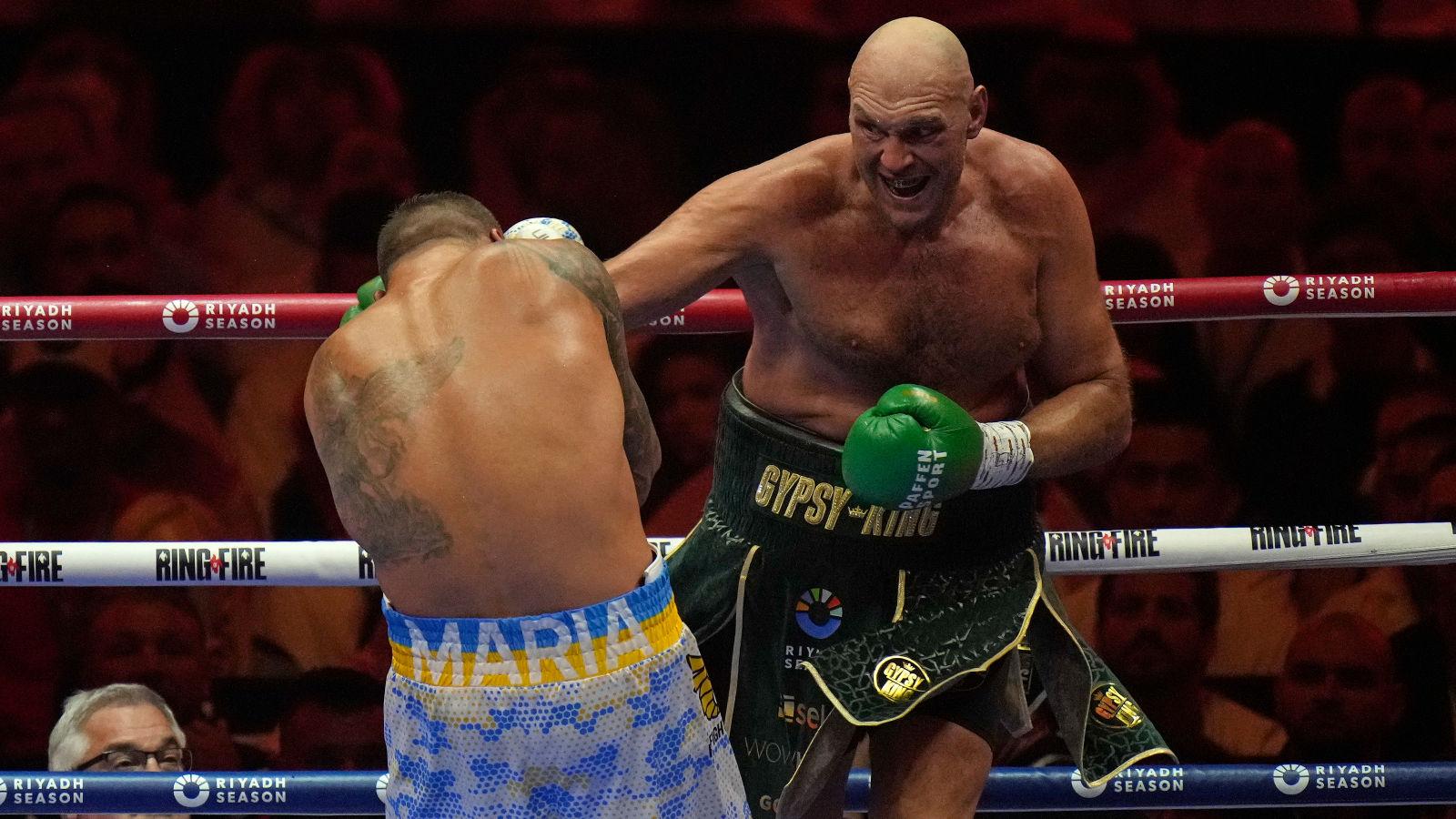 Tyson Fury punches Oleksandr Usyk