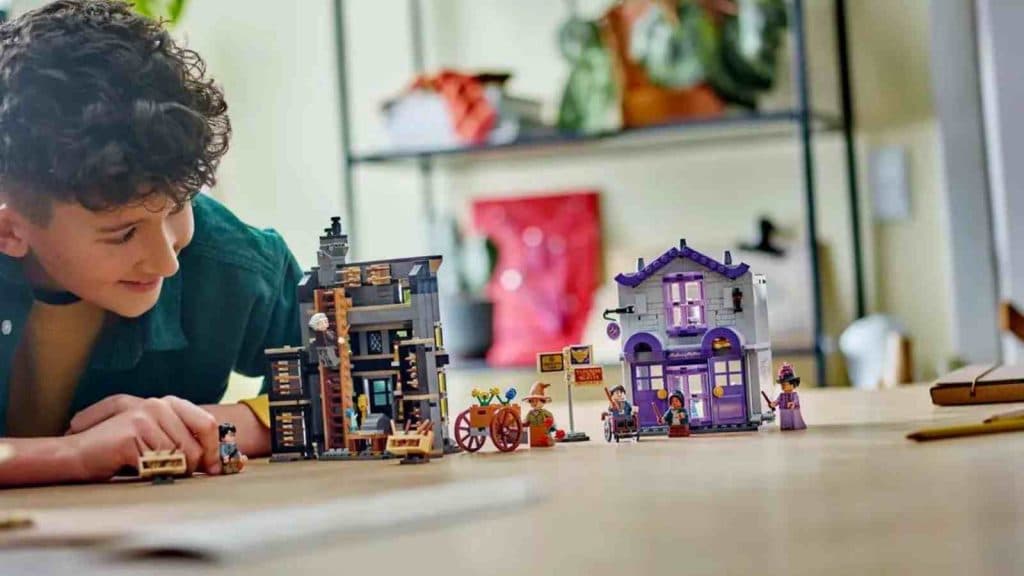 A child playing with their LEGO Harry Potter Ollivanders & Madam Malkin's Robes set
