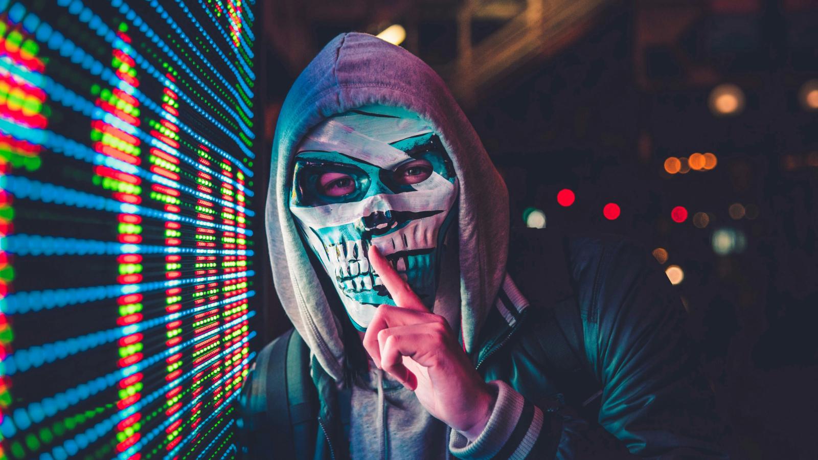 Image of a person wearing a mask, next to cryptic background.